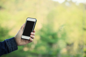 closeup of hands using smartphone taking photo outdoor