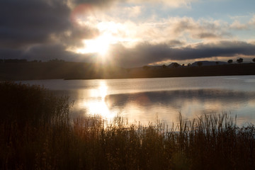 sunrise over pond or dam