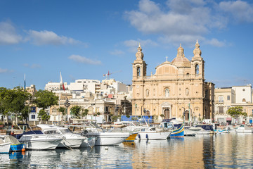 Fototapeta na wymiar Traditional fishing boats at Valetta Harbor, Malta