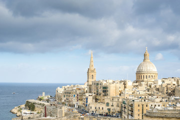 Fototapeta na wymiar View of a church dome of Valetta over the roofs. Malta