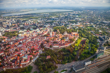Fototapeta na wymiar Aerial view from helicopter of red roofs and parks of old town of Tallinn, Estonia. Summer time