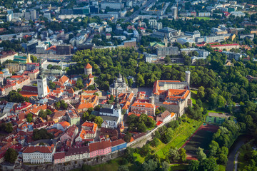 Aerial view from helicopter of red roofs and parks of old town of Tallinn, Estonia. Summer time