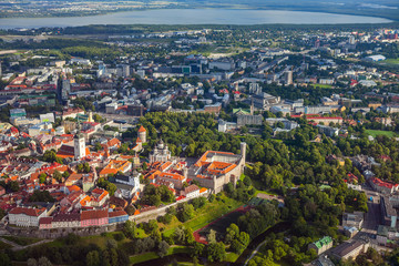 Aerial view from helicopter of red roofs and parks of old town of Tallinn, Estonia. Summer time