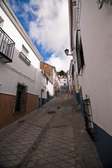 streets of the quarter of las Cruces, neighborhood very typical of this city, in the background the castle of La Mota, Alcala La real, Spain