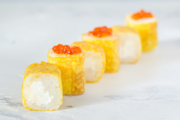 Rolls with caviar in an omelette on a white background