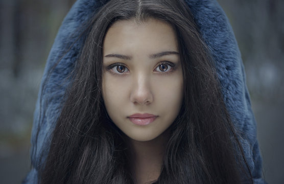 Portrait of serious Mixed Race teenage girl wearing blue hood