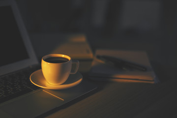 Coffee cup on laptop keypad