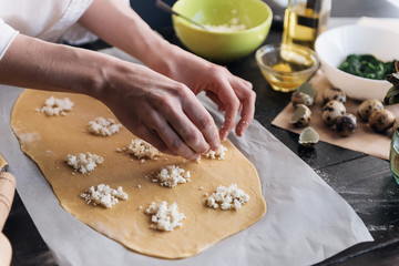 Step by step the chef prepares ravioli with ricotta cheese, yolks quail eggs and spinach with spices. The chef prepares the filling on the dough