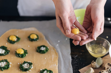 Step by step the chef prepares ravioli with ricotta cheese, yolks quail eggs and spinach with spices. The chef prepares the filling on the dough