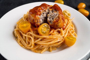 Spaghetti pasta with meatballs, tomato sauce. on dark background with copy space
