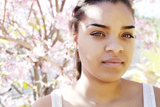 Portrait of serious Mixed Race woman outdoors