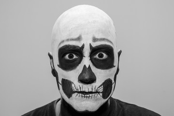 Beautiful man with creative make-up for the Halloween party