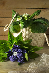 Bouquet of flowers and a wicker basket on a wooden background 4