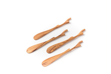 Four wooden butter spreader on a white background