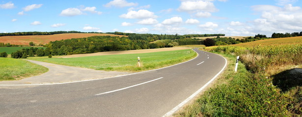Strasse durch eine farbige Herbstlandschaft bei der Siedlung Maiermund im mittleren Hunsrück...