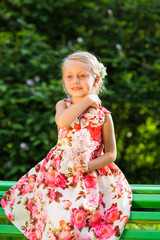 young child girl sitting and having rest during forest walk