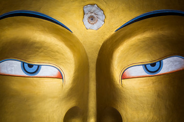 Close up of colourful sculpture of Maitreya Buddha at Thiksey monastery in the Indian Himalaya....