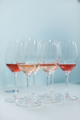 Row of glasses with white and rose wines prepared for degustation - vertical shot