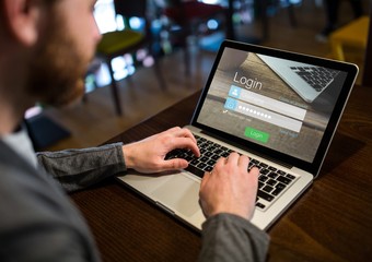 Men in a cafeteria with the laptop with login screen