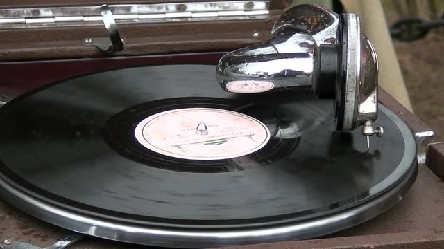 Retro gramophone player from a losing phonograph vinyl record. Vintage music player for hearing music and songs. Recording technology on the media in the last century. The story of the old equipment.
