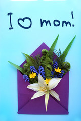 i live mom/Envelope with flowers and ferns on a bluebackground.