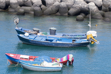 Four small colored boats in the harbor.