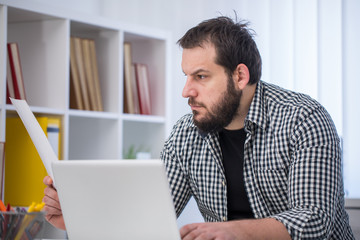 Man working hard in office alone