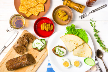 Breakfast or lunch for two on white table. Top view