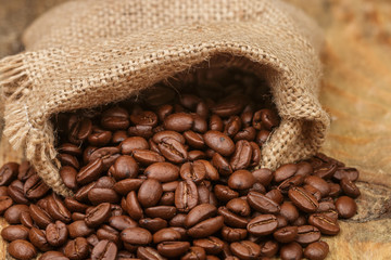 Coffee beans closeup on wooden table. Selective focus