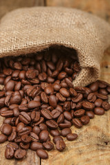 Coffee beans closeup on wooden table. Selective focus