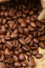 Coffee beans closeup on wooden table. Selective focus