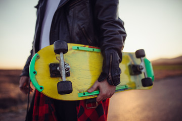 Skater holding yellow skateboard © Dzelat