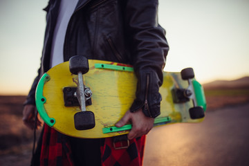 Skater holding yellow skateboard © Dzelat