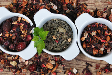 Dried tea in white three ceramic containers