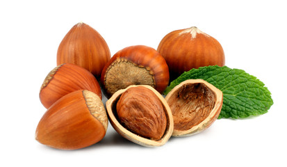hazelnuts with green leaf isolated on white background