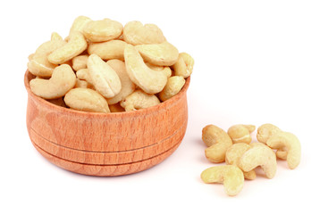 cashew in wood plate isolated on white background