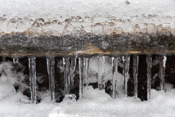 Icicles hanging from a wooden staircase in the street