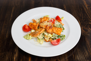 Fototapeta na wymiar Plate with fresh caesar salad with chicken