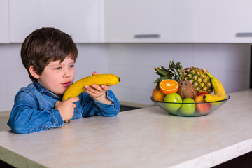 Little boy with a bowl of fresh fruits