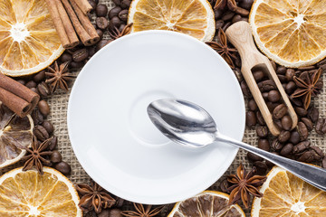 orange slices with coffee beans and spices on canvas background