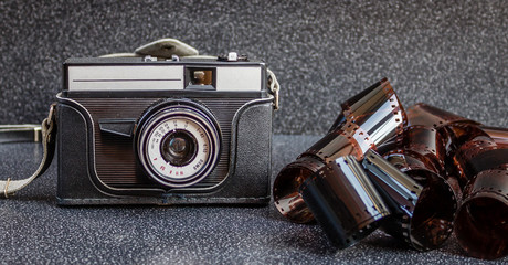 An old camera and film tapes