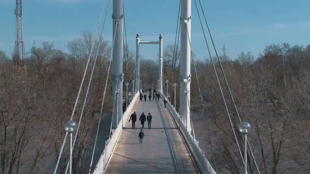 White pedestrian bridge crossing the Ural river