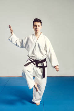 girl, Taekwondo is martial Stoke hands in fists, focused, serious look in the Studio on isolated background