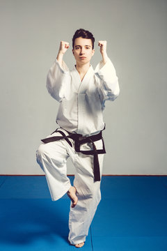 girl, Taekwondo is martial Stoke hands in fists, focused, serious look in the Studio on isolated background