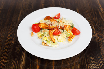 Plate with fresh caesar salad with chicken