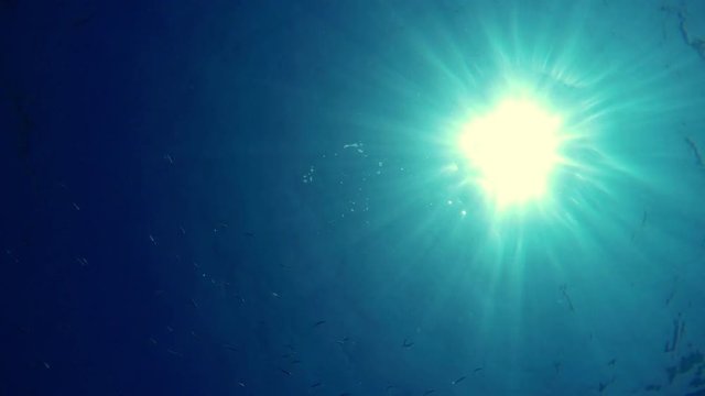 Underwater GoPro shots, sun rays through the water, splashes and bubles