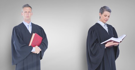 Judges holding books in front of grey wall