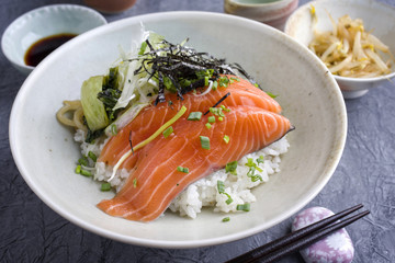 Traditional Japanese Hokkaidon Thinly sliced salmon Donburi as close-up in a bowl