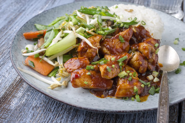 Chicken sweet-sour with Vegetable and white Rice as close-up on a plate