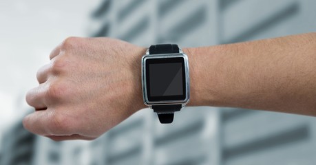 Hand with watch and flare against blurry building